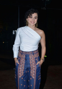 Taapsee Pannu looks fab in a white one-shoulder top, and royal blue printed trousers during the pre-release event of Mishan Impossible.