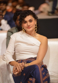 Taapsee Pannu looks fab in a white one-shoulder top, and royal blue printed trousers during the pre-release event of Mishan Impossible.